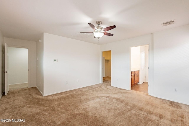 unfurnished bedroom featuring ceiling fan and light carpet