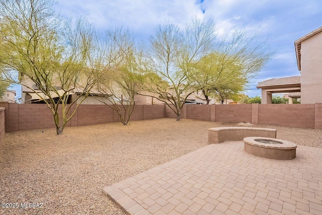 view of patio with a fire pit