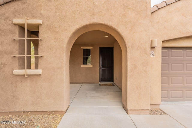 view of exterior entry with a garage