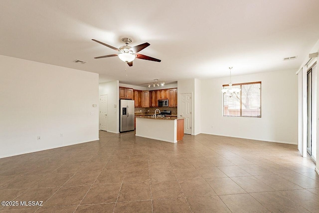 unfurnished living room with sink and ceiling fan