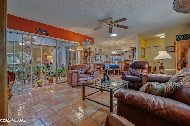 tiled living room with ceiling fan and a textured ceiling