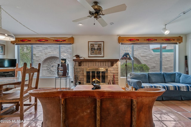 living room with track lighting, tile patterned floors, and ceiling fan