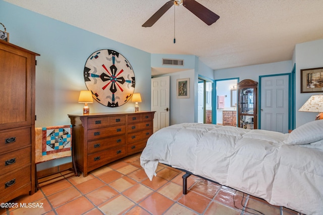 bedroom with light tile patterned flooring, ceiling fan, and a textured ceiling