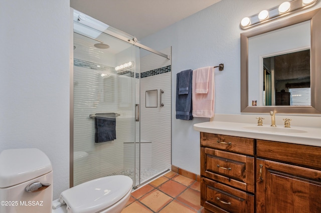 bathroom with an enclosed shower, vanity, tile patterned floors, and toilet