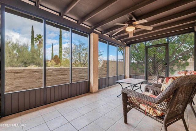 sunroom featuring ceiling fan and beamed ceiling