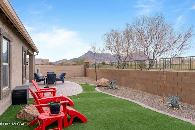 view of yard featuring a mountain view and a patio area