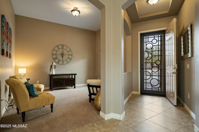 foyer featuring light colored carpet