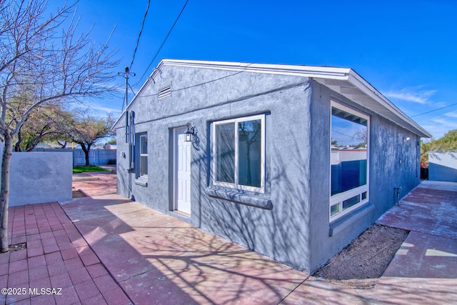 view of side of property featuring a patio