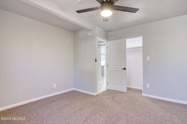 unfurnished bedroom with ceiling fan and carpet floors