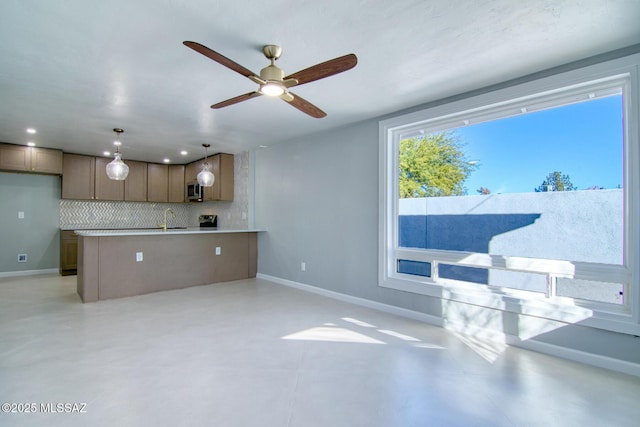 kitchen with pendant lighting, backsplash, and ceiling fan