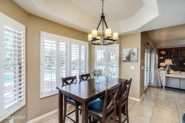1943 W Desert Highlands Dr, Oro Valley, AZ 85737 - dining area with a chandelier, baseboards, light tile patterned floors, and a raised ceiling