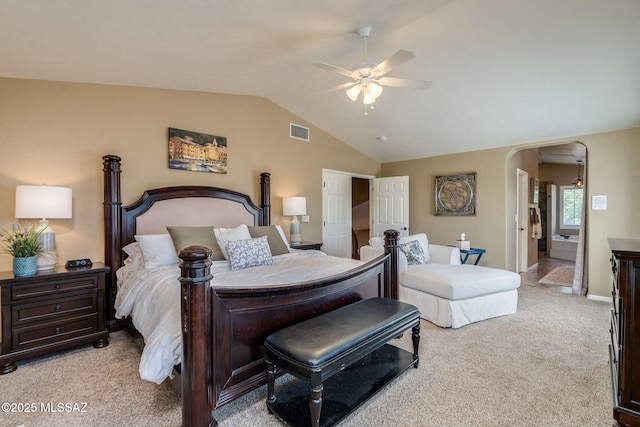 1943 W Desert Highlands Dr, Oro Valley, AZ 85737 - bedroom featuring light carpet, vaulted ceiling, arched walkways, and a ceiling fan