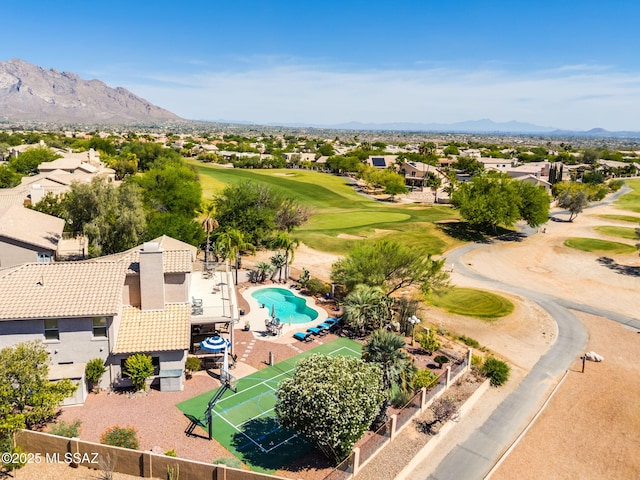 1943 W Desert Highlands Dr, Oro Valley, AZ 85737 - aerial perspective of suburban area featuring a local golf course, a mountain backdrop, and a pool