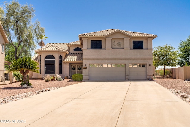 1943 W Desert Highlands Dr, Oro Valley, AZ 85737 - mediterranean / spanish-style house featuring concrete driveway, an attached garage, stucco siding, and a tile roof