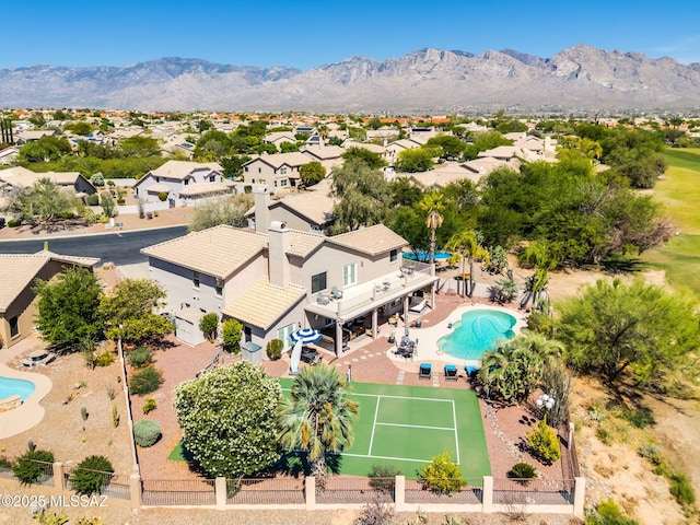1943 W Desert Highlands Dr, Oro Valley, AZ 85737 - aerial perspective of suburban area featuring a pool area and mountains