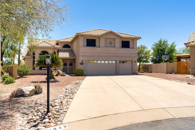 1943 W Desert Highlands Dr, Oro Valley, AZ 85737 - mediterranean / spanish house with a tiled roof, an attached garage, stucco siding, and driveway