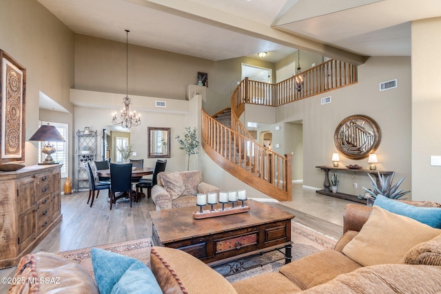 1943 W Desert Highlands Dr, Oro Valley, AZ 85737 - living room with stairway, high vaulted ceiling, a chandelier, and beamed ceiling