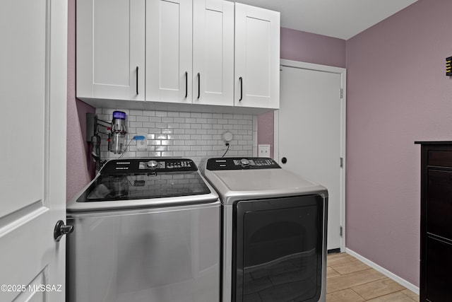 laundry room with independent washer and dryer, cabinets, and light wood-type flooring