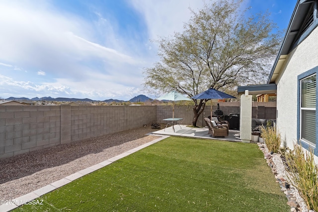 view of yard featuring a mountain view and a patio