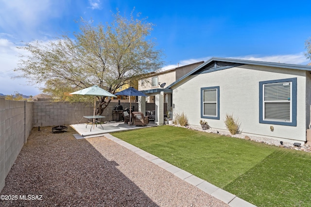 back of house with a patio and a lawn