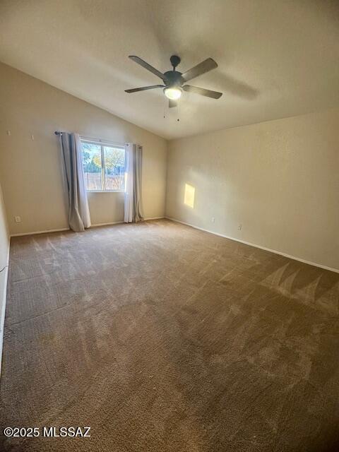 empty room with vaulted ceiling, carpet, a textured ceiling, and ceiling fan