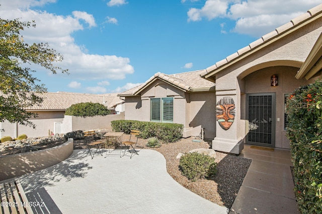 view of exterior entry featuring a patio