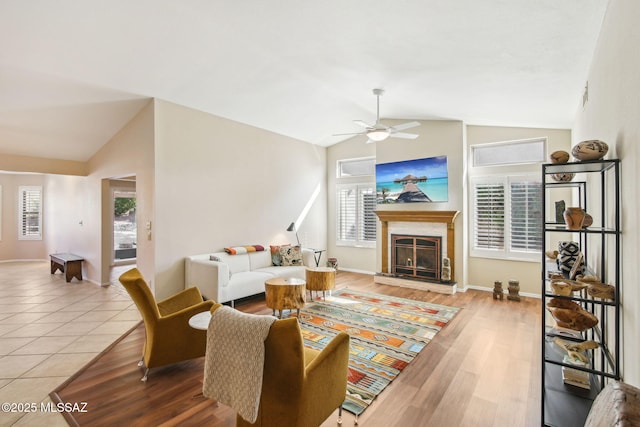 living room with lofted ceiling, plenty of natural light, and light wood-type flooring