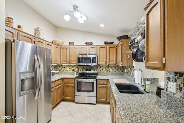 kitchen with tasteful backsplash, sink, light tile patterned floors, and stainless steel appliances