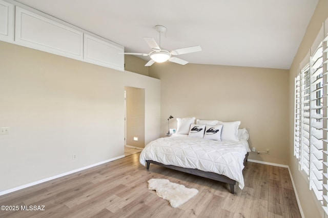 bedroom with vaulted ceiling, ceiling fan, and light hardwood / wood-style floors