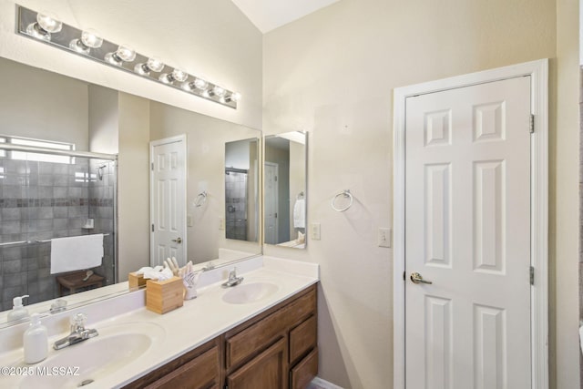 bathroom with a shower with door and vanity