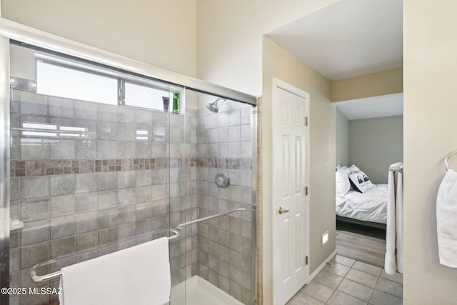 bathroom with tile patterned floors and a shower with shower door