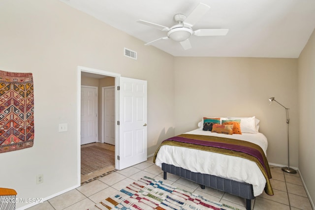 bedroom featuring ceiling fan, vaulted ceiling, and light tile patterned floors