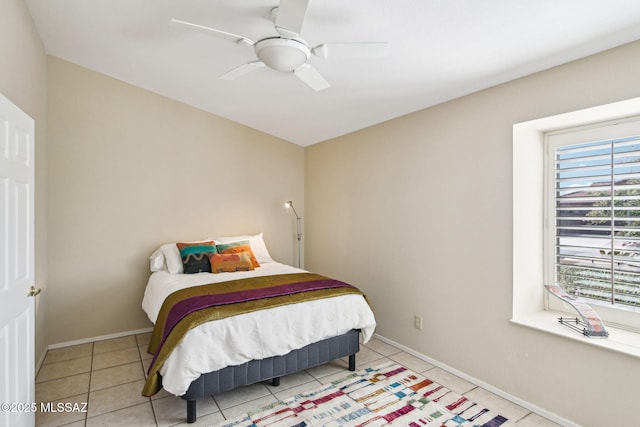 tiled bedroom with ceiling fan