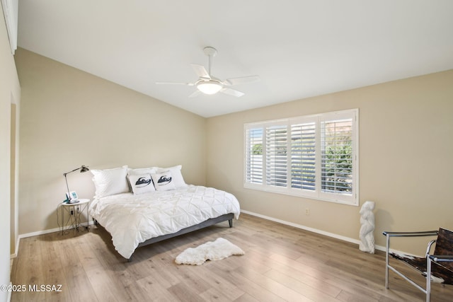 bedroom with lofted ceiling, hardwood / wood-style floors, and ceiling fan