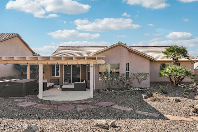 rear view of property with an outdoor living space and a patio area