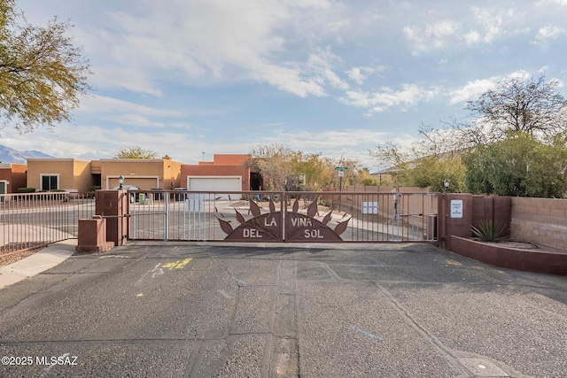 view of gate with a garage