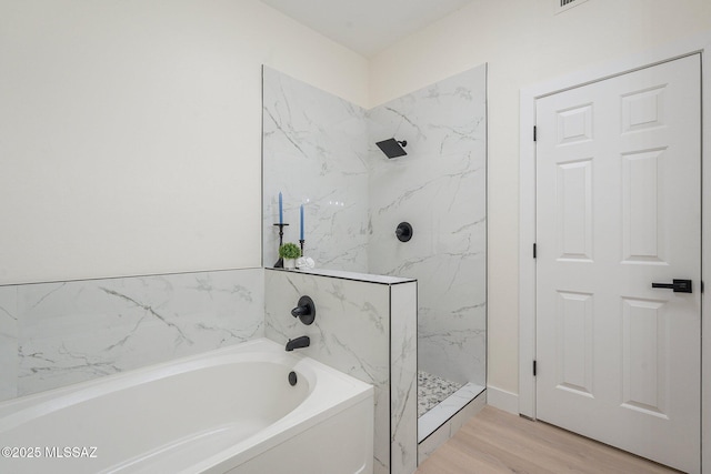 bathroom featuring hardwood / wood-style flooring and independent shower and bath