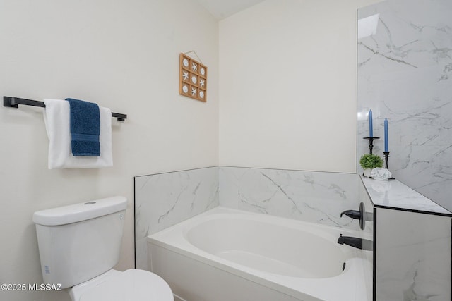 bathroom with vanity, toilet, and a bathing tub