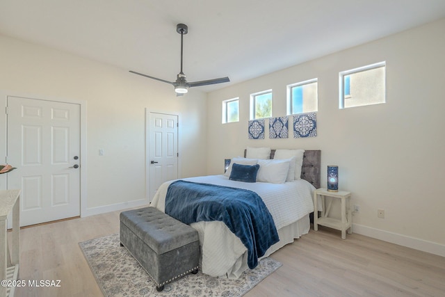 bedroom with ceiling fan and light hardwood / wood-style flooring