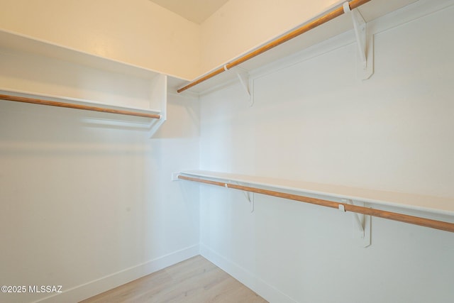 spacious closet with light hardwood / wood-style floors