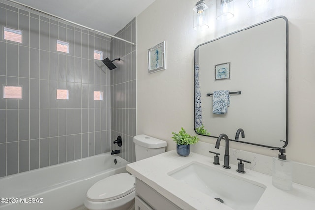 full bathroom with tiled shower / bath combo, vanity, and toilet