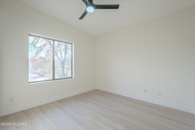 empty room with light hardwood / wood-style flooring, vaulted ceiling, and ceiling fan