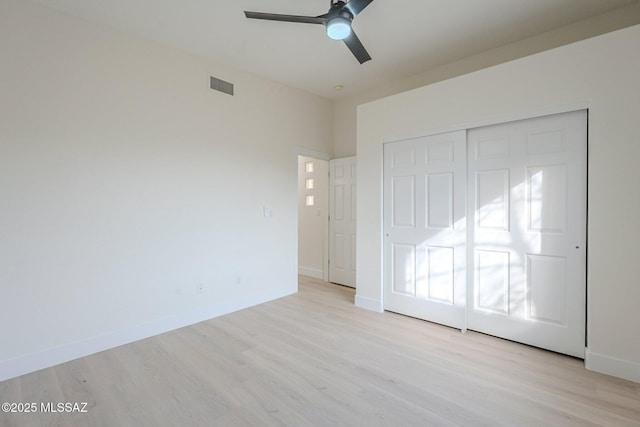 unfurnished bedroom featuring a closet, ceiling fan, and light hardwood / wood-style flooring