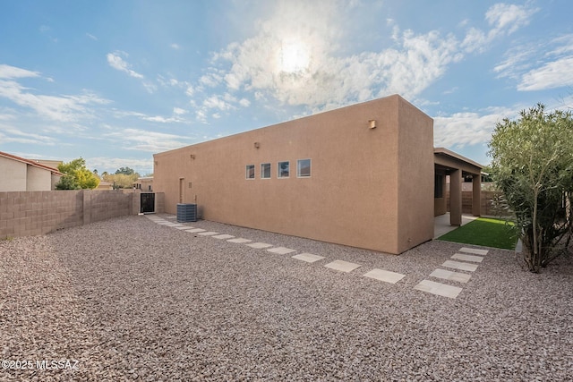 back of property with a patio and central AC