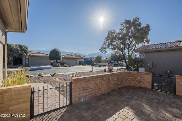 view of patio with a mountain view and a garage