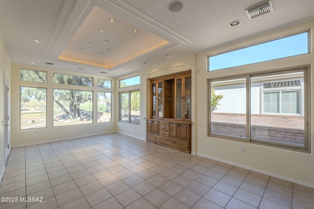 interior space featuring a wealth of natural light and a raised ceiling