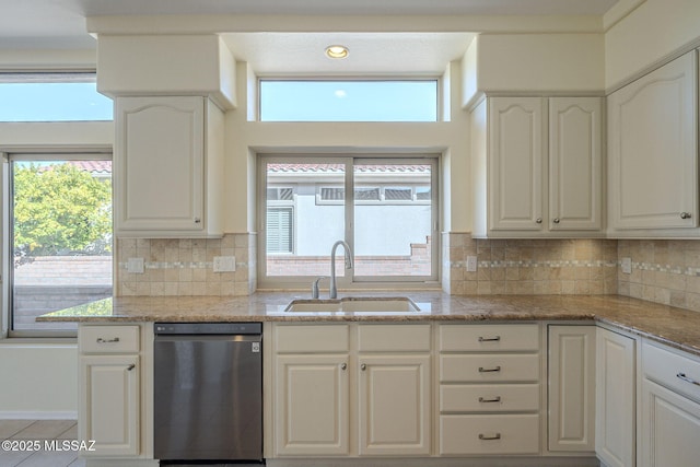 kitchen with white cabinetry, dishwasher, sink, and light stone countertops