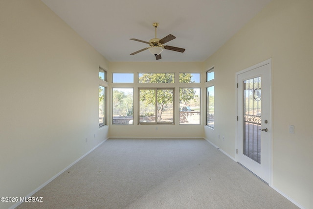 unfurnished sunroom with ceiling fan and a wealth of natural light