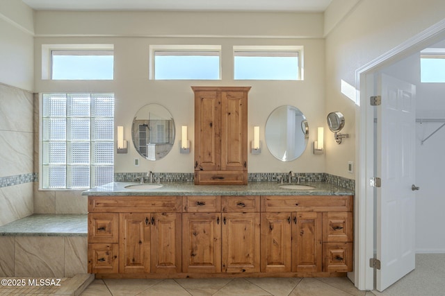 bathroom with vanity, tile patterned floors, and a high ceiling