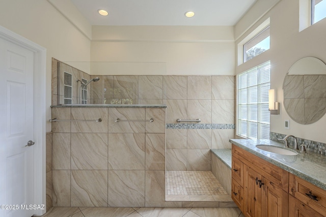 bathroom featuring vanity and tiled shower